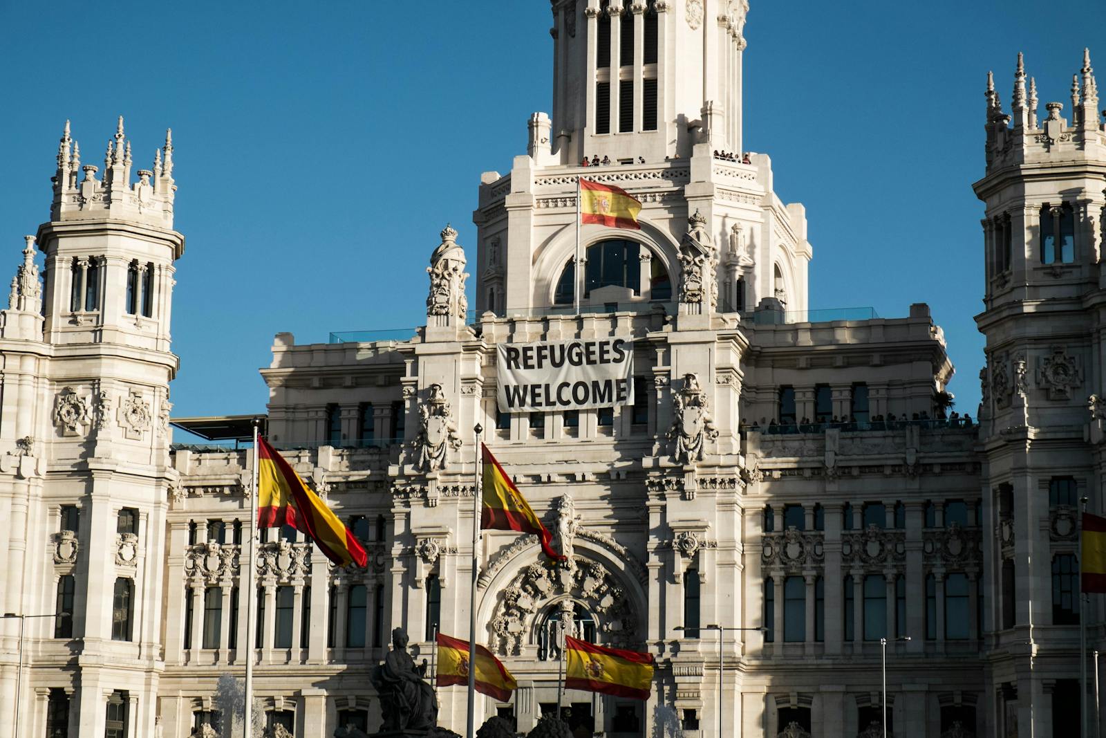 Cybele Palace front with banners and flags in Madrid, Spain.